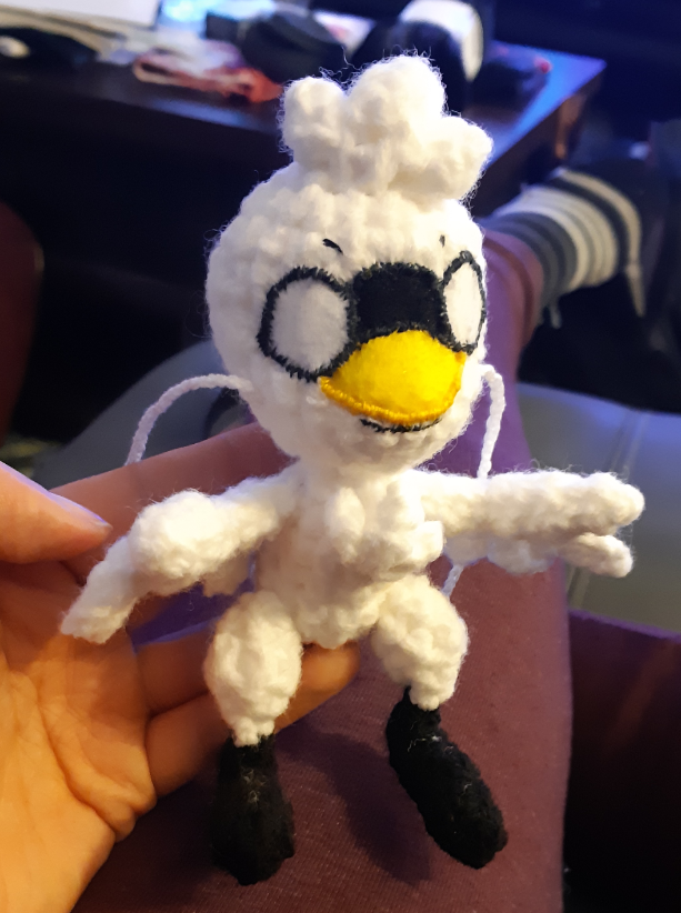 Swan Kwami amigurumi, showing all pieces assembled without eyes painted on